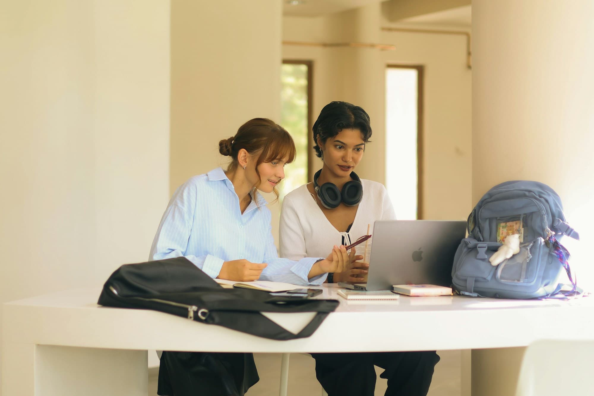 Two learners following an online course together on a laptop
