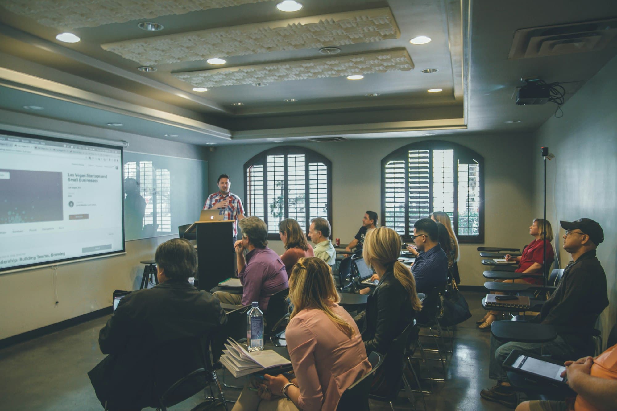 Participants following a presentation in a training room
